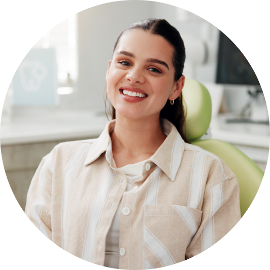 Smiling woman seated comfortably before a dental appointment.