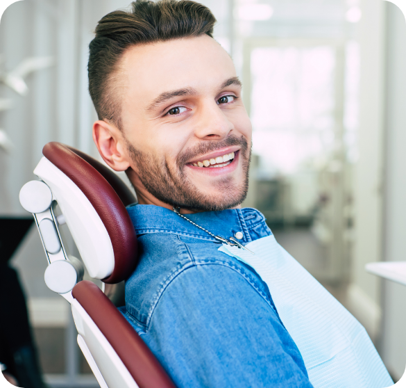 Smiling man relaxing in a dental chair before treatment.