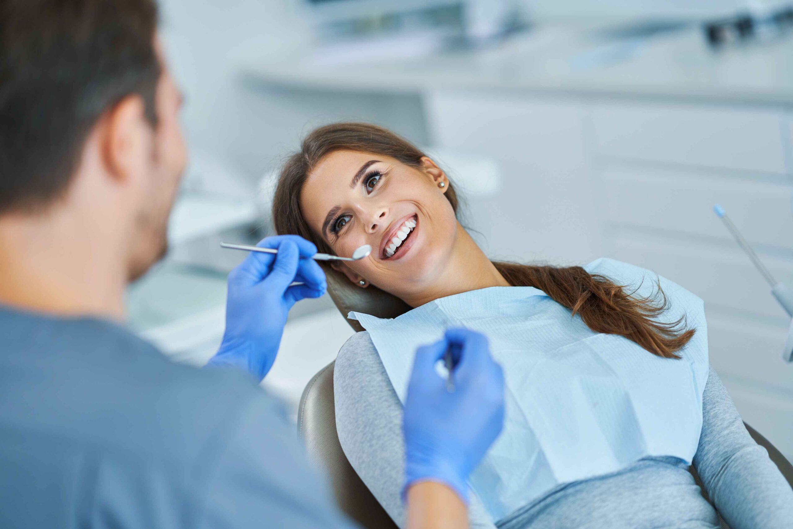 Smiling patient undergoing a routine dental checkup.