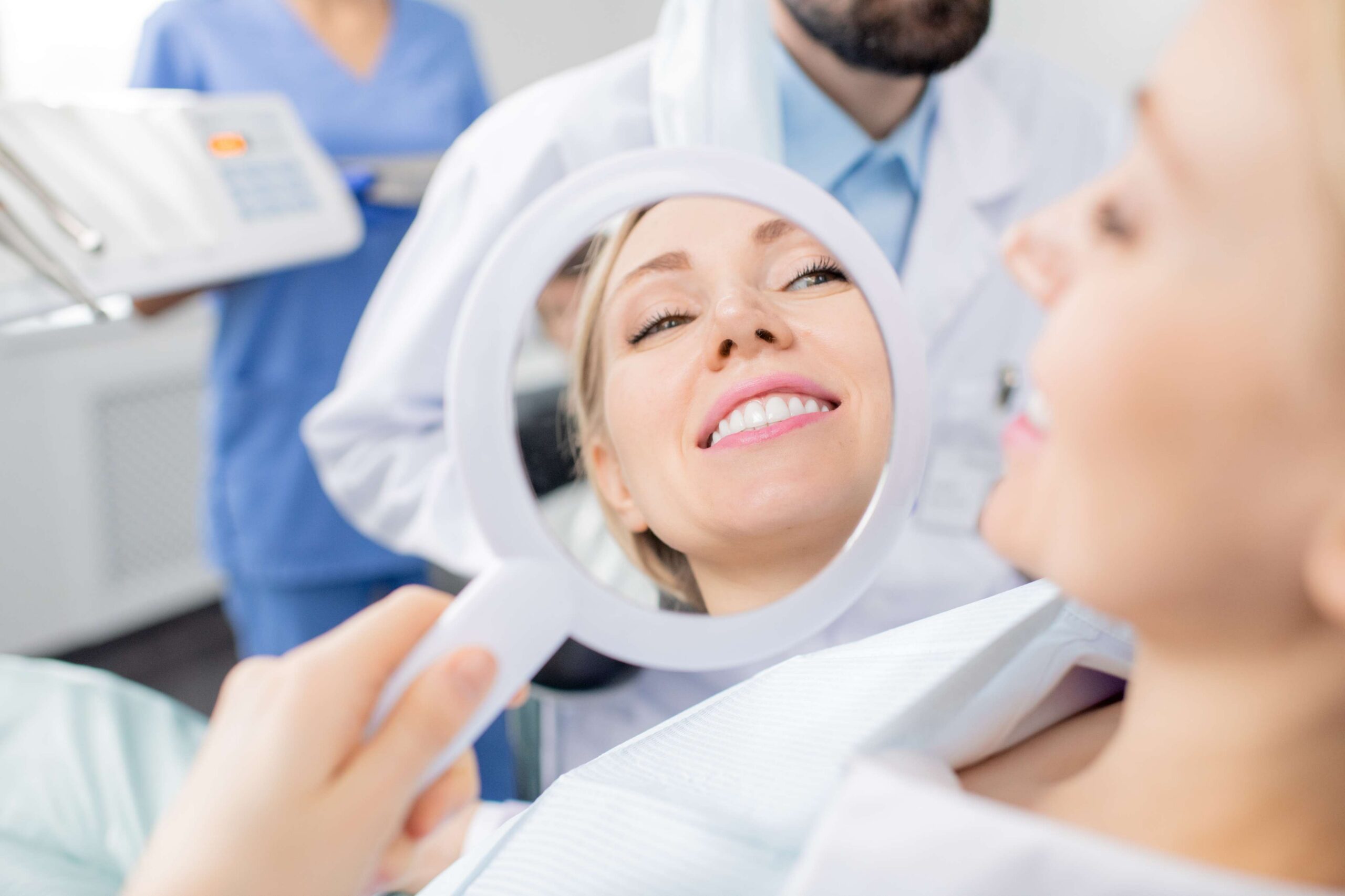 Patient viewing her smile in a mirror