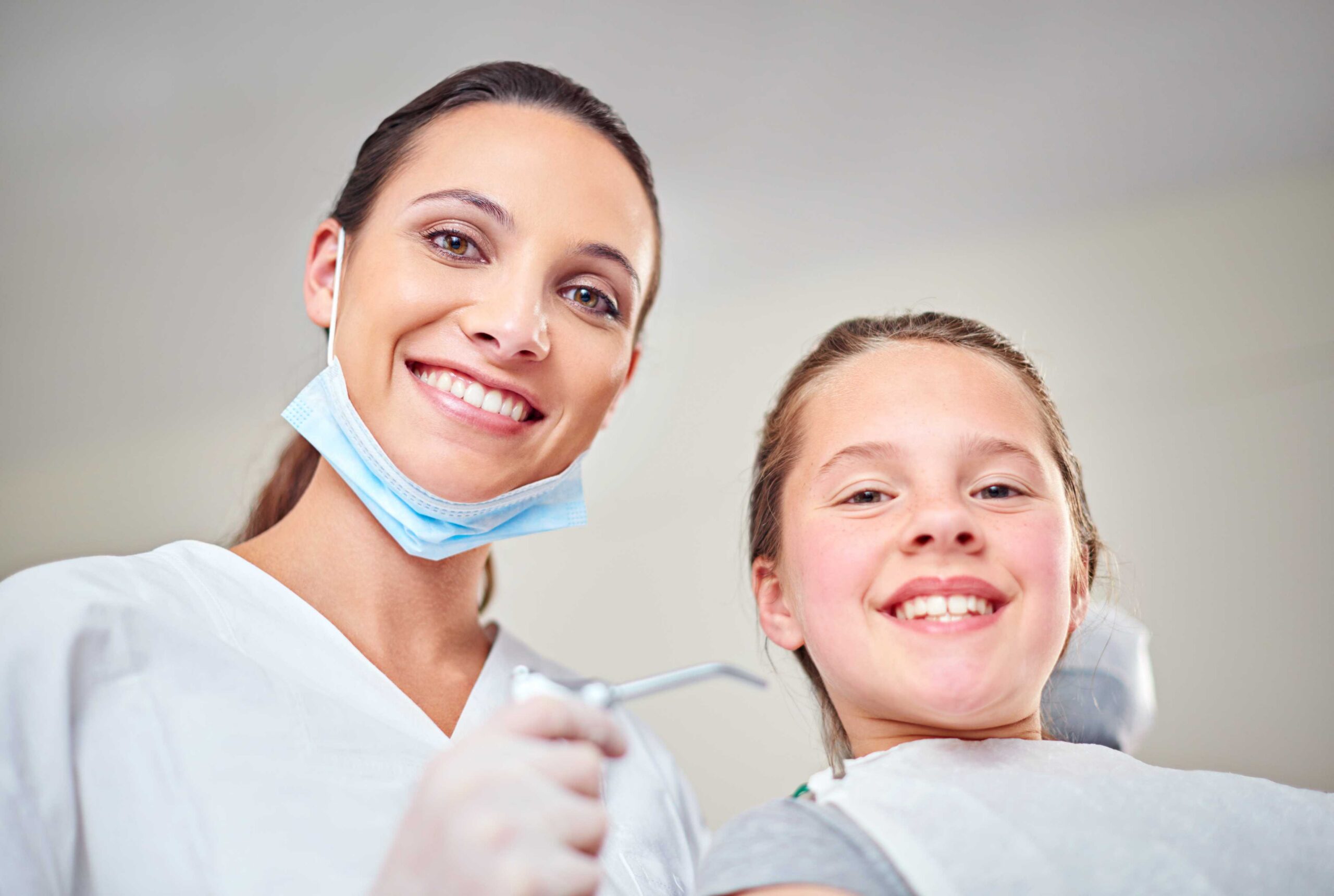Dentist with smiling young patient